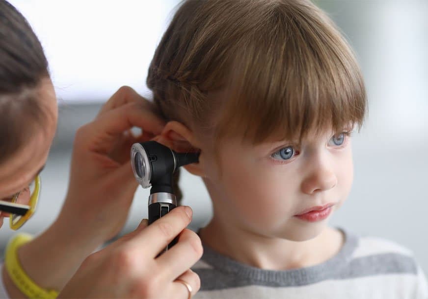 a child has their ear inspected