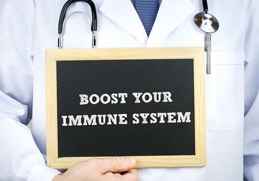 Doctor with sign reading 'boost your immune system