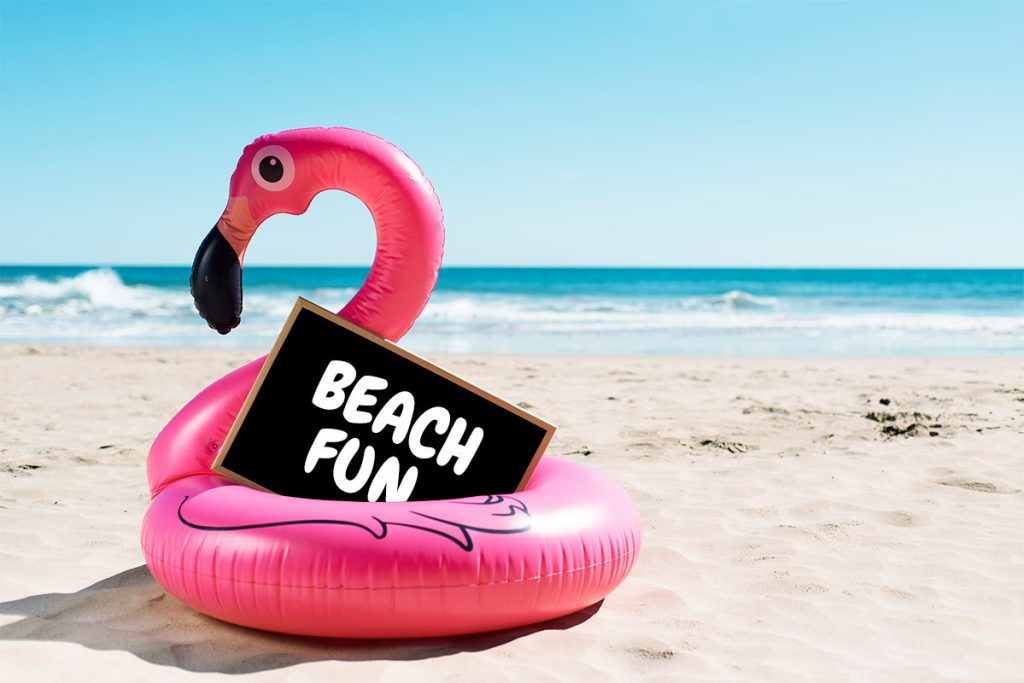 an inflatable flamingo sits on the beach