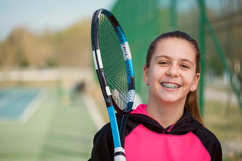 A young girl is excited to play tennis