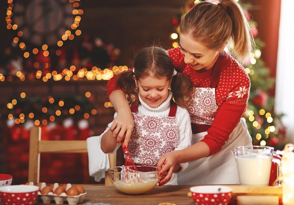 A mother and daughter make Christmas treats