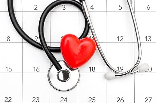 a stethoscope rests on a calendar