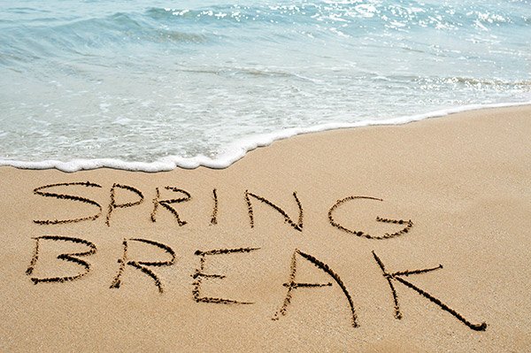 someone has written spring break in the sand on a beach