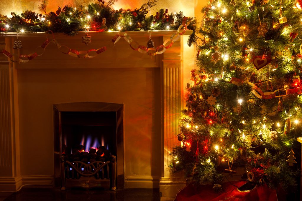 a christmas tree in front of a fireplace